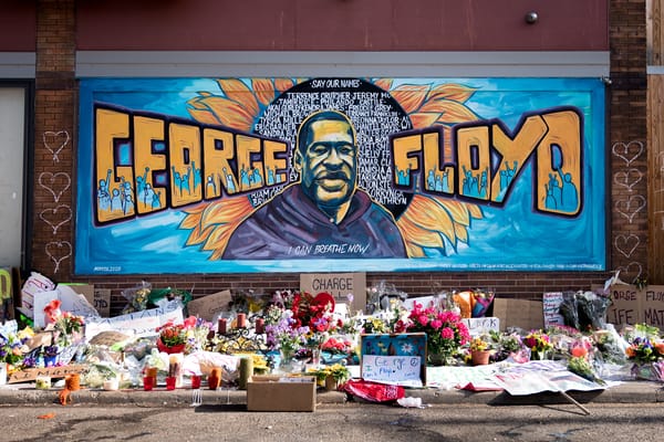 Image of yellow and blue mural George Floyd in Chicago, and memorial with flowers and handmade signs.