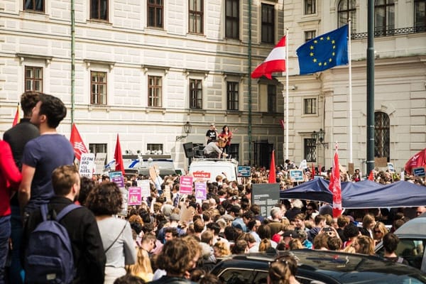 Isabel Frey stands o a truck holding a guitar before a large crowd of protesters against the right-wing government in Vienna.