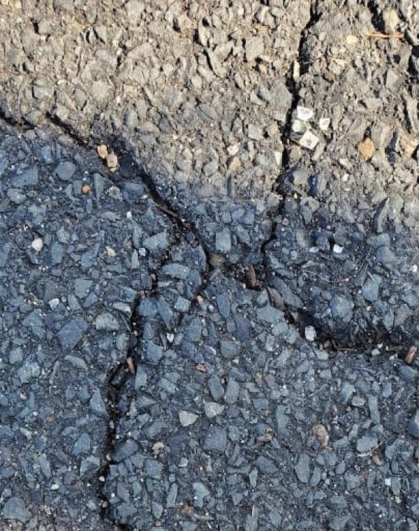 A Hebrew letter aleph made out of cracks in the pavement.